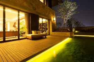 bench on wooden floor near pond at night